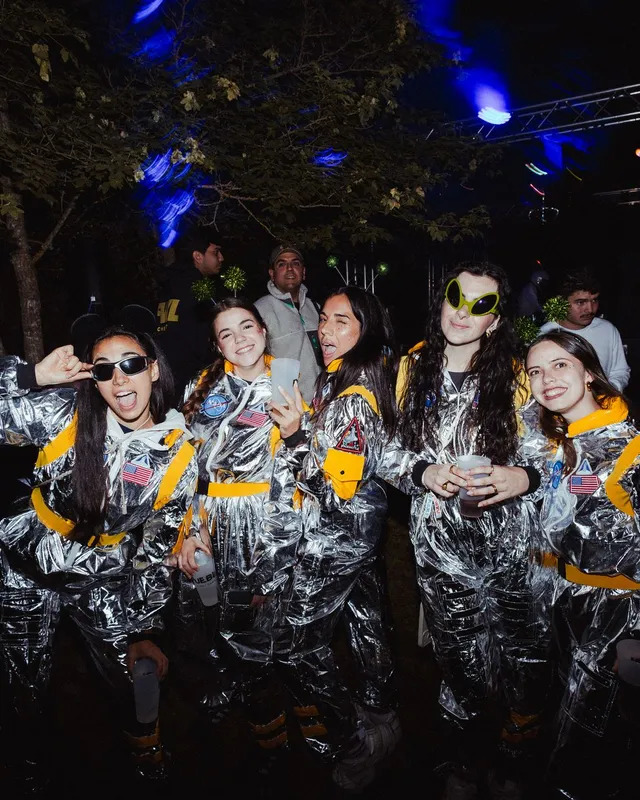 Seis amigas con trajes plateados de astronauta posan en la fiesta espacial del jueves