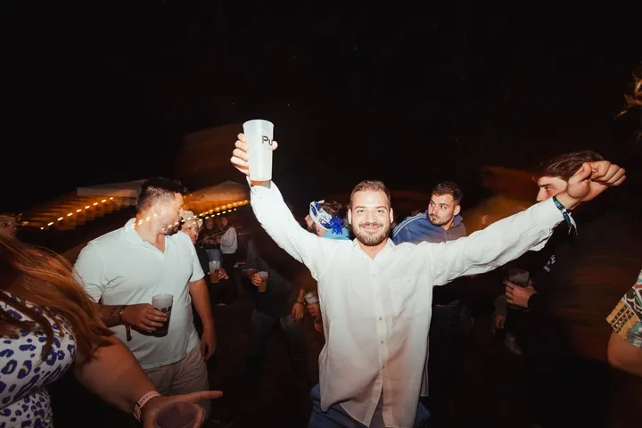 Un chico levanta los brazos en la última fiesta